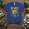 Family Over Everything quote with silhouette of parents and child in a scenic mountain sunset design on a blue t-shirt