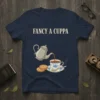 Fancy A Cuppa text above a teapot pouring tea into a floral cup with biscuits on a navy t-shirt design