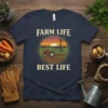 Farm Life Best Life t-shirt with a vintage sunset graphic featuring a tractor plowing a field and a windmill