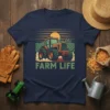 Navy blue t-shirt with "FARM LIFE" text and a vintage tractor graphic in a field, representing agricultural living