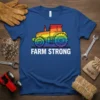 Farm Strong text with a rainbow tractor graphic on a blue t-shirt