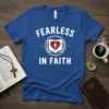 Blue t-shirt with white text "FEARLESS IN FAITH" and a graphic of an open book with a heart and cross