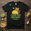 T-shirt with text FEED ME TACOS AND TELL ME I'M I'M PRETTY I'M PRETTY and a cartoon cat eating a