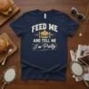 Feed Me And Tell Me I'm Pretty text with burger graphic on a navy t-shirt