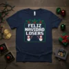 Feliz Navidad Losers text in pixelated font with snowmen and candy canes on a navy blue t-shirt
