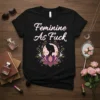 Feminine As Fuck quote on a black t-shirt with a lotus and silhouette graphic