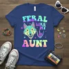 Feral Like My Aunt t-shirt design with a cartoon wolf and skeleton hand giving rock-on sign
