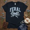 Feral graphic t-shirt with a blue and white floral bow design, showcasing a wild spirit theme