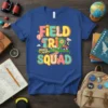 Retro FIELD TRIP SQUAD text with bus, mountains, and hot air balloons on a blue t-shirt