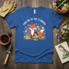Find Me In The Flowers t-shirt with a fox, girl, and colorful flowers design