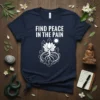 Find Peace in the Pain t-shirt with lotus flower, roots, and crystals graphic, white design on navy tee