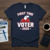 First Time Voter 2020 t-shirt design featuring bold white text with red and blue accents, a graphic of a hand