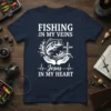 Fishing In My Veins Jesus In My Heart quote with fish and cross design on navy t-shirt