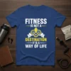 White and yellow text on a navy blue t-shirt that reads "FITNESS IS NOT A DESTINATION IT IS A WAY