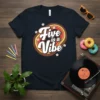 Retro "Five is a Vibe" text design with groovy font and floral accents on a navy t-shirt