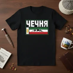 Black t-shirt with white text 'Чечня' above a flag design featuring mountains and gold emblem
