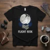 Flight Risk Goose Witch T-Shirt design featuring a goose in a witch hat standing on books under a full moon