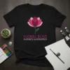 Floral Bliss Nature's Masterpeice text with a pink lotus flower graphic on a black t-shirt