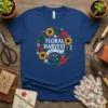 Floral Harvest Grow Wild text with a floral wreath design on a navy t-shirt, featuring sunflowers and poppies