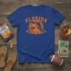 Florida Gators "FLORIDA VS ALL Y'ALL" text and graphic t-shirt design in orange on a royal blue tee