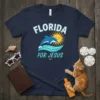 Florida For Jesus t-shirt with a jumping dolphin, bright sun, and ocean waves graphic