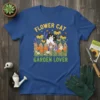 Flower Cat Garden Lover t-shirt with a black and white cat peeking over a wooden fence surrounded by colorful flowers