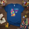 Blue t-shirt with a colorful floral cat design and the text "FLOWER POWER CAT" in bold lettering