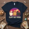 Fluffy But Fierce text with three stylized chickens in front of a sunset graphic on a navy t-shirt