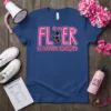 FLYER CHEERLEADING SQUAD text with a silhouetted cheerleader mid-jump holding pom-poms, on a navy blue t-shirt