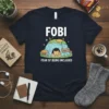 FOBI Fear Of Being Included T-Shirt with a cute cartoon cat inside a fort, surrounded by books and a "No