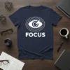 Navy blue t-shirt with a white graphic featuring an eye icon and the word "FOCUS" in bold capital letters