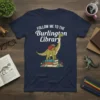 Follow Me To The Burlington Library text with a cartoon dinosaur carrying books on a stack of books