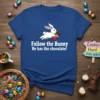White bunny running with a chocolate bar, text "Follow the Bunny He has the chocolate!" on a royal blue t-shirt