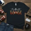 Black t-shirt with "Football MOM" design, featuring white script for "Football" and leopard print block letters with a football in