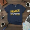 Navy blue t-shirt with yellow and white text reading "FRAGILE I JUST DROPPED MY SON OFF AT COLLEGE"
