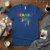 Framily text in rainbow colors above diverse stick figures holding hands in a circle, symbolizing unity on a blue t-shirt