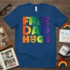 Free Dad Hugs text with rainbow heart graphic on a navy blue t-shirt
