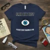 Navy t-shirt with "FREE EYE TEST PLEASE STOP STARING AT ME" text and a blue-eyed eye graphic