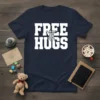 Navy blue t-shirt with bold white text "FREE HUGS" and two figures embracing graphic