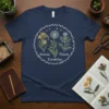 Freesia Thistle Dandelion botanical design with wildflowers arranged in a circle on a navy blue t-shirt