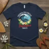 French Polynesia Teahupoo Tahiti t-shirt design featuring a large ocean wave, two people in a canoe, and tropical flowers