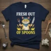 Fresh Out Of Spoons humorous quote t-shirt design with a cartoon cat chef holding a fork and knife