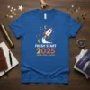 Blue t-shirt with "FRESH START 2025 DREAM GROW ACHIEVE" text and a rocket graphic, featuring constellations and moons