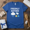 Freshly Bathed t-shirt with cute cartoon cloud raining on two rubber ducks and a bar of soap labeled "Clean"