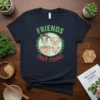 Friends Not Food vegan t-shirt design featuring a cow, pig, and sheep inside a circle, with green text and red