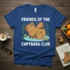Friends of the Capybara Club t-shirt featuring three cute capybaras in water with lily pads