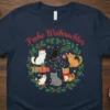 Frohe Weihnachten text above a circular design of various cats wearing Santa hats and festive decorations on a navy t-shirt