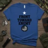 Blue t-shirt with black text "FRONT TOWARD ENEMY" and a black and white American flag circle, front view
