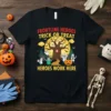Frontline Heroes Trick or Treat Heroes Work Here text on a black t-shirt with Halloween graphics including a spooky tree