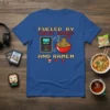 Fueled by Indie Games and Ramen t-shirt design featuring pixel art game console and ramen bowl